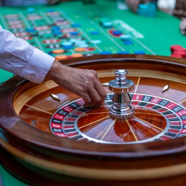 a man is playing a game of roule on a green table