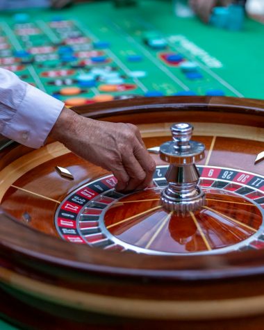 a man is playing a game of roule on a green table