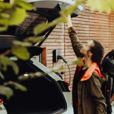 a man standing next to a parked car