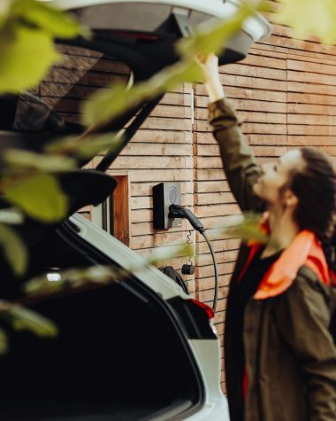 a man standing next to a parked car