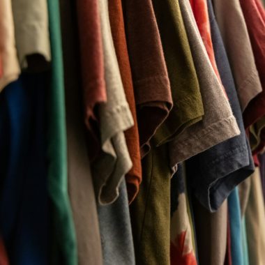 assorted clothes hanged on rack