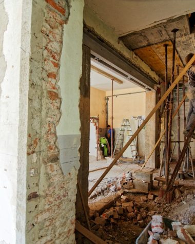 man climbing on ladder inside room